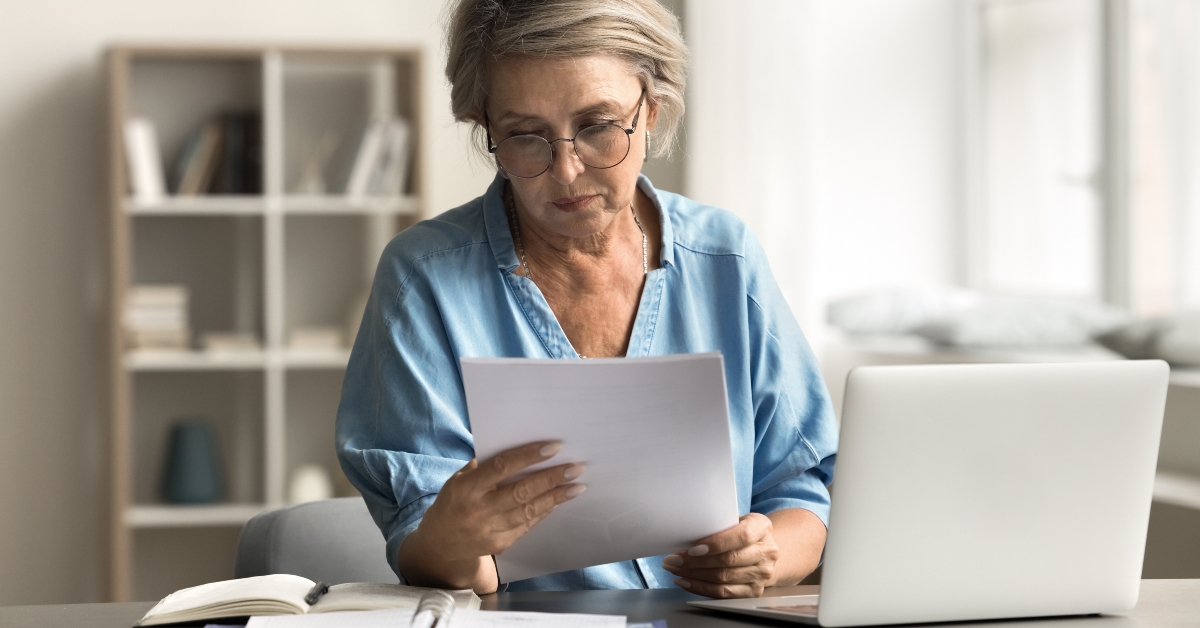 older woman reading document