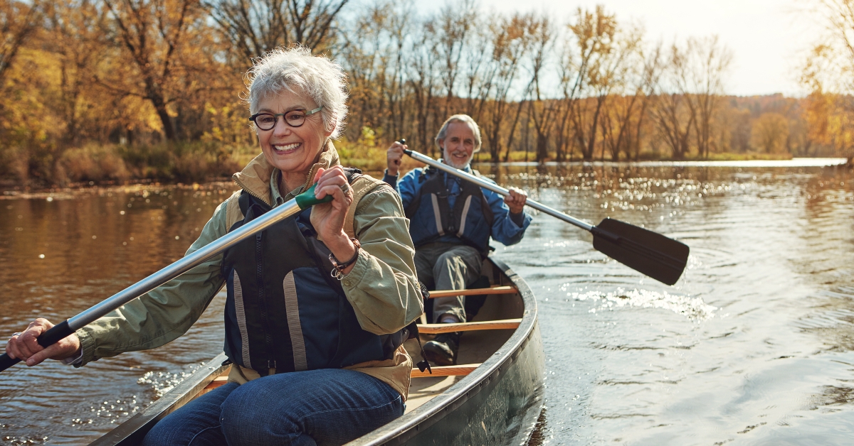 Senior couple rowing kayak