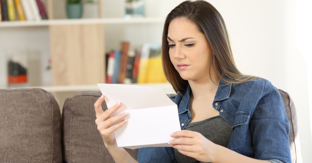 Suspicious female reading a letter
