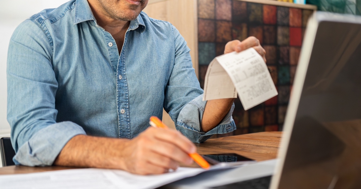 middle-aged man calculating taxes