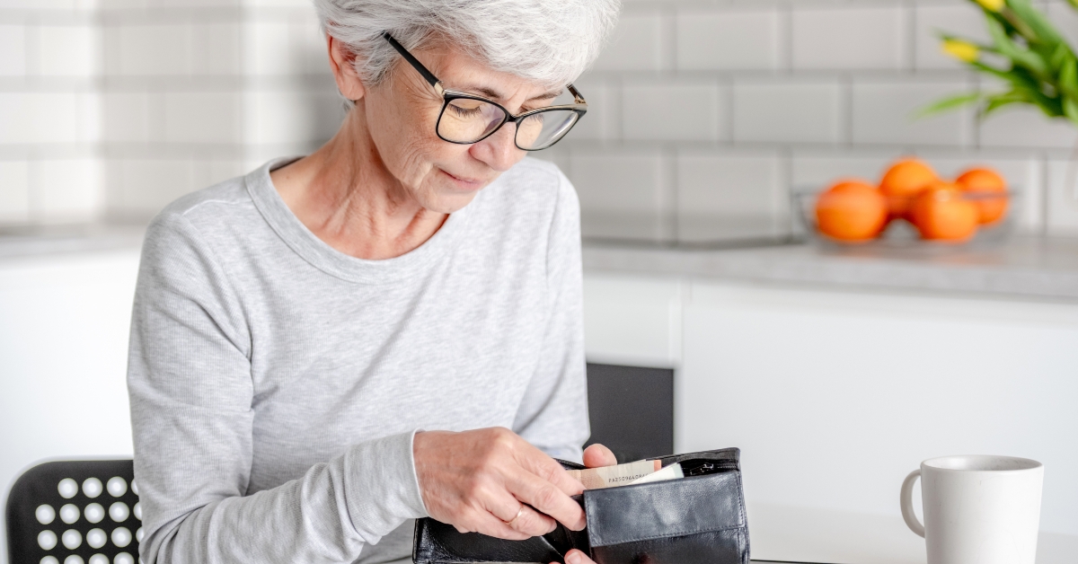 elderly woman counts money