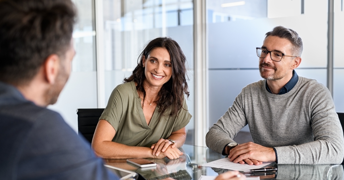 mature couple discussing investment with finance advisor