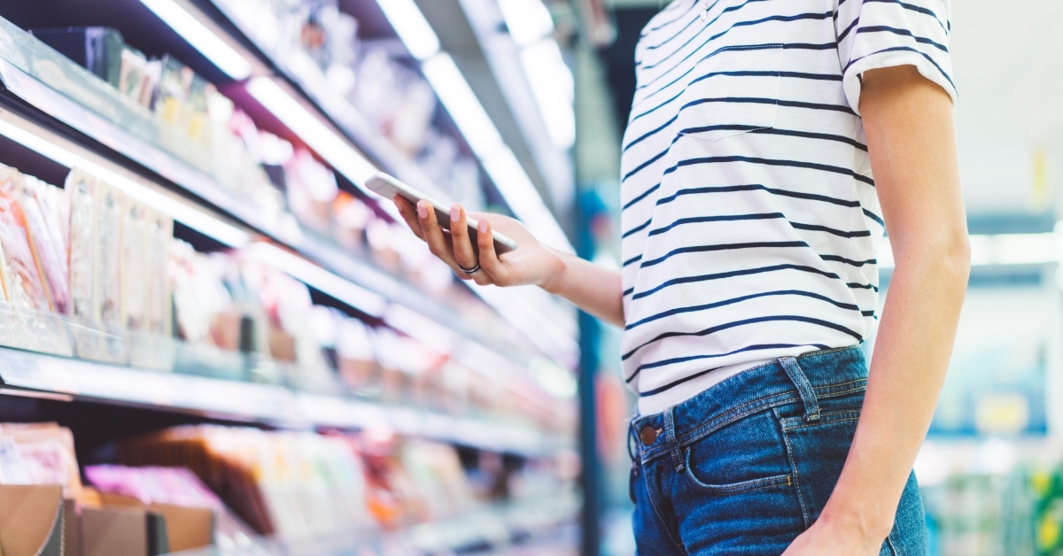 woman reading grocery list on smartphone
