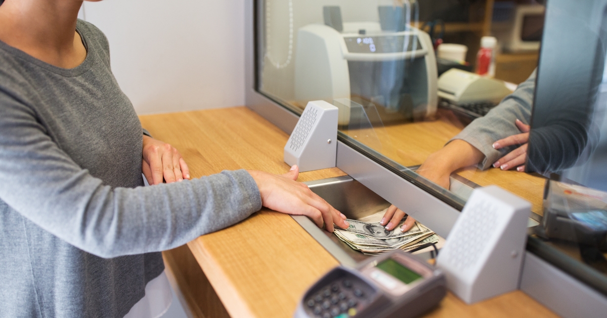 clerk giving cash money at bank