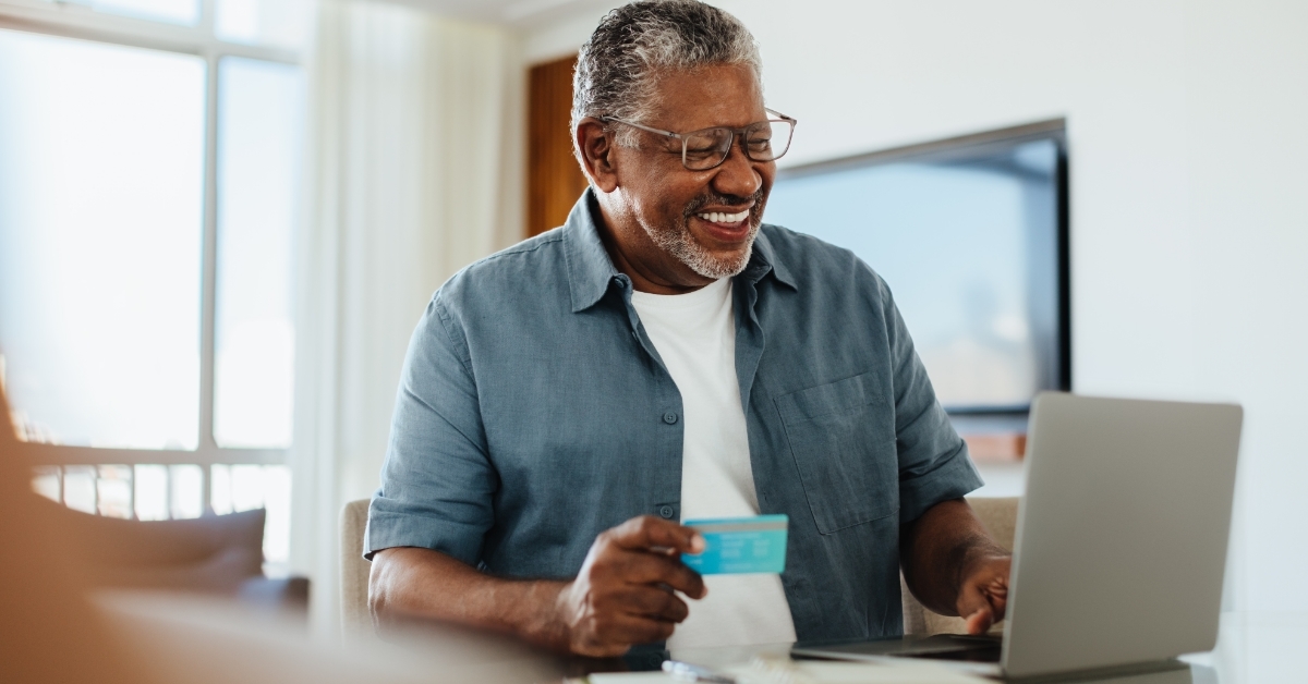 senior man shopping online using laptop