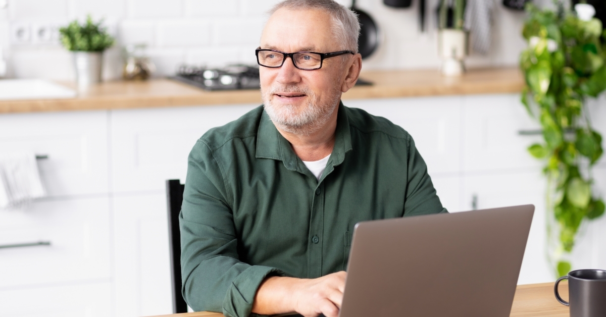 senior man working from home using laptop