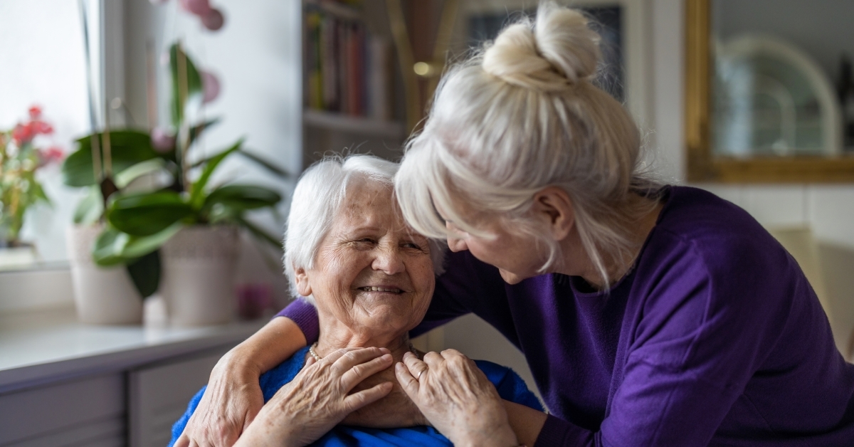 woman hugging aged mother 