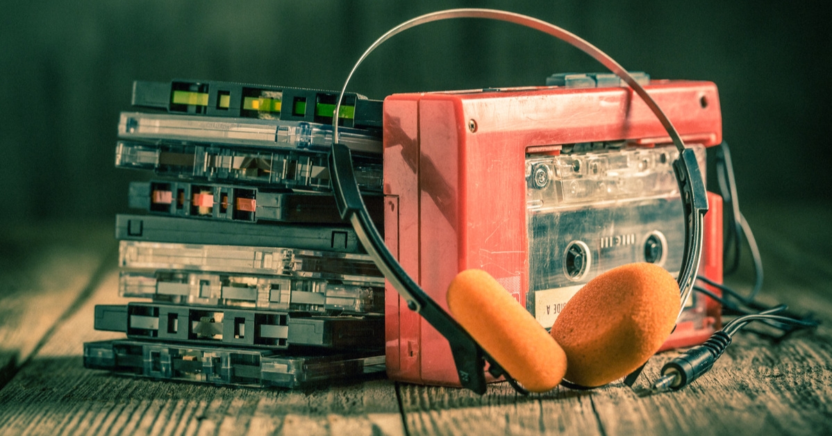 old tape walkman and pile of cassette tapes