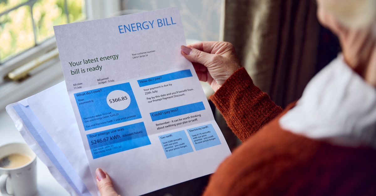 senior woman opening uk energy bill