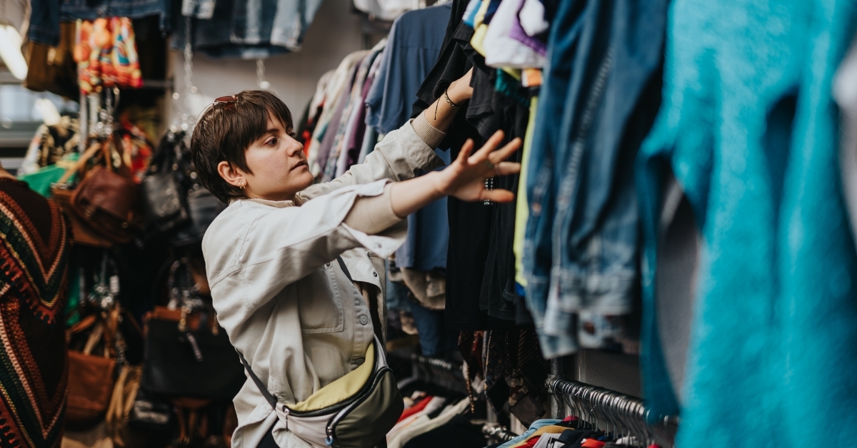 woman browsing clothes at thrift store