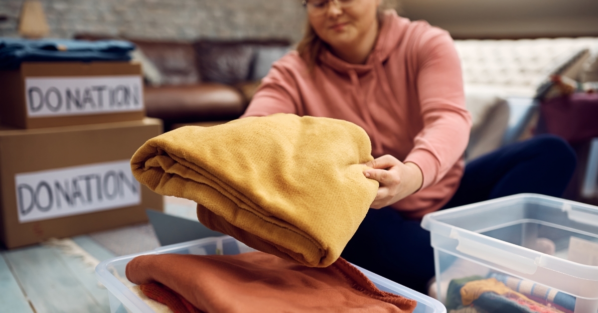 woman packing clothes for donation