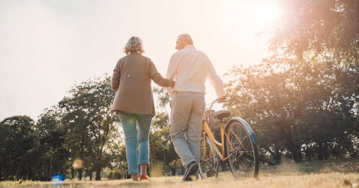 Senior Couple Holding Bike