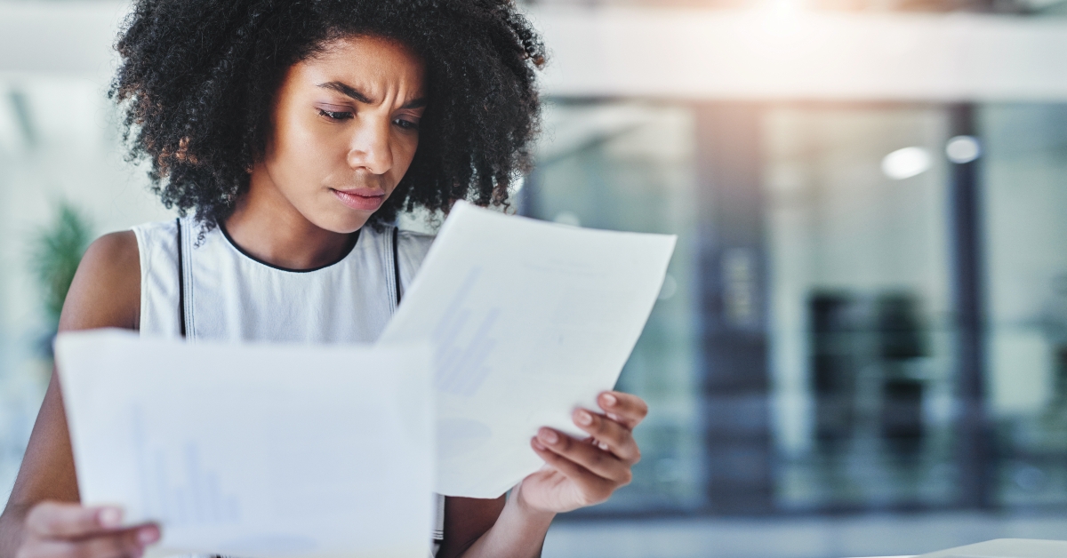 Frustrated woman reading paperwork