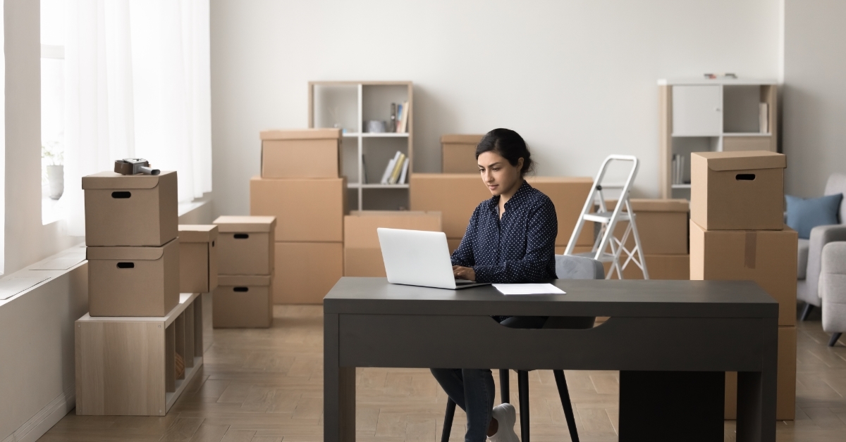woman working on laptop at warehouse