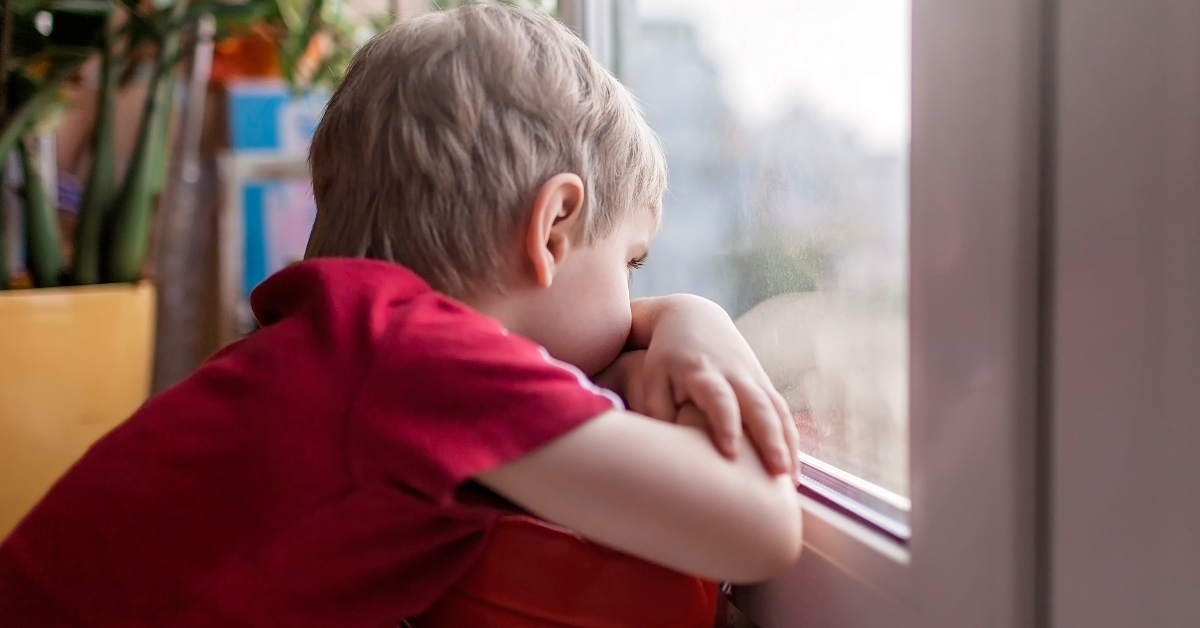 little kid sitting on the windowsill