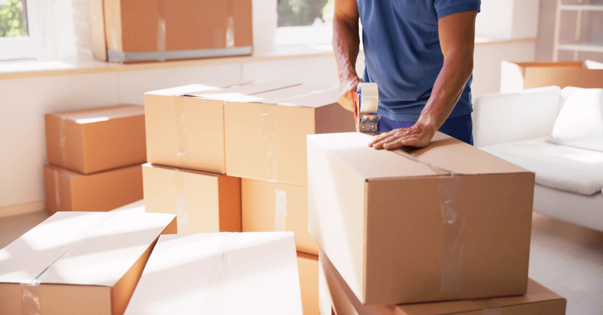 man packing boxes for move