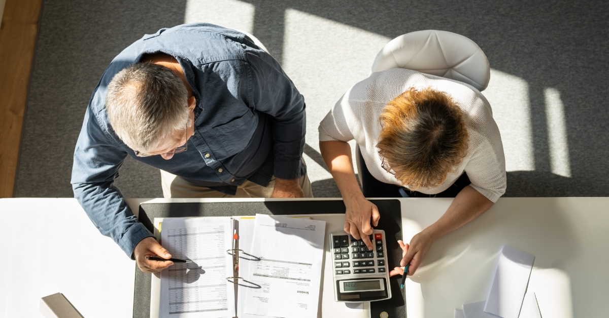 couple calculating bills together at home