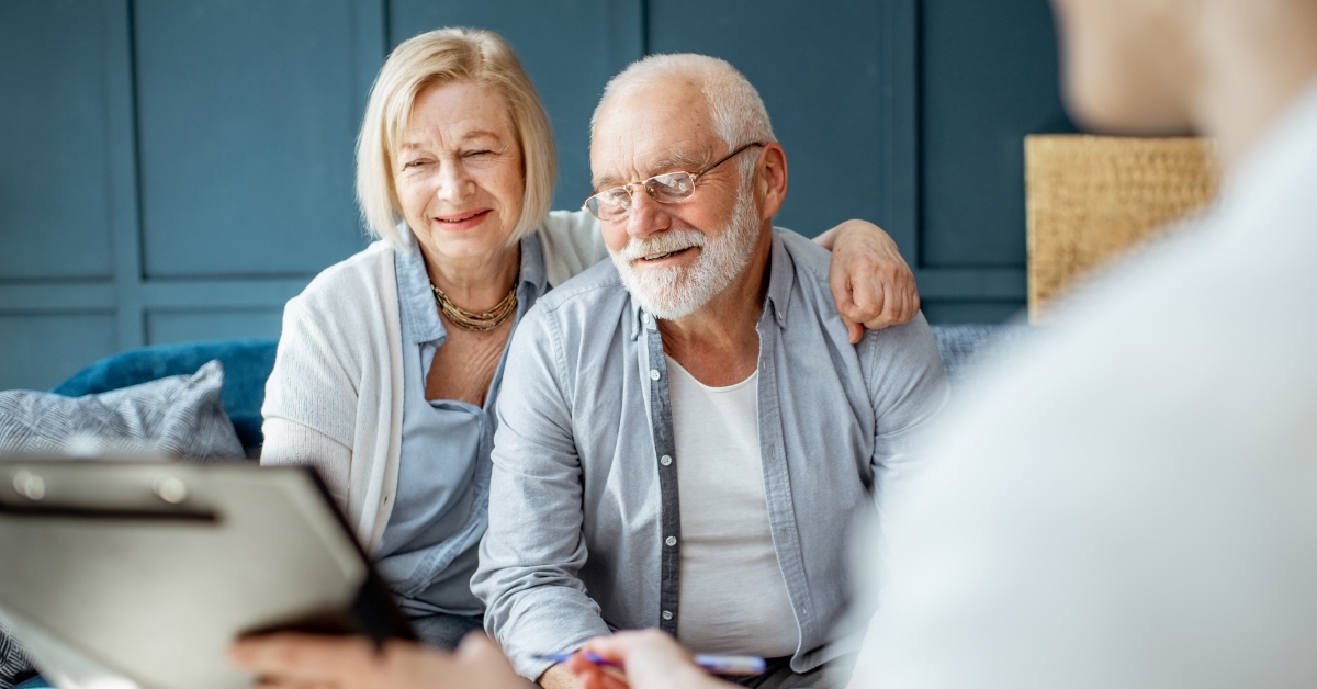 Senior couple signing agreement with finance advisor