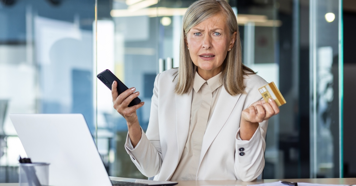 holding a phone and a credit card
