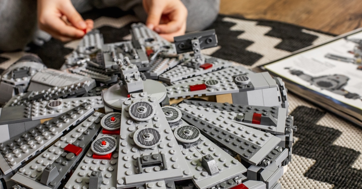 boy collecting spaceship from Lego Millennium Falcon