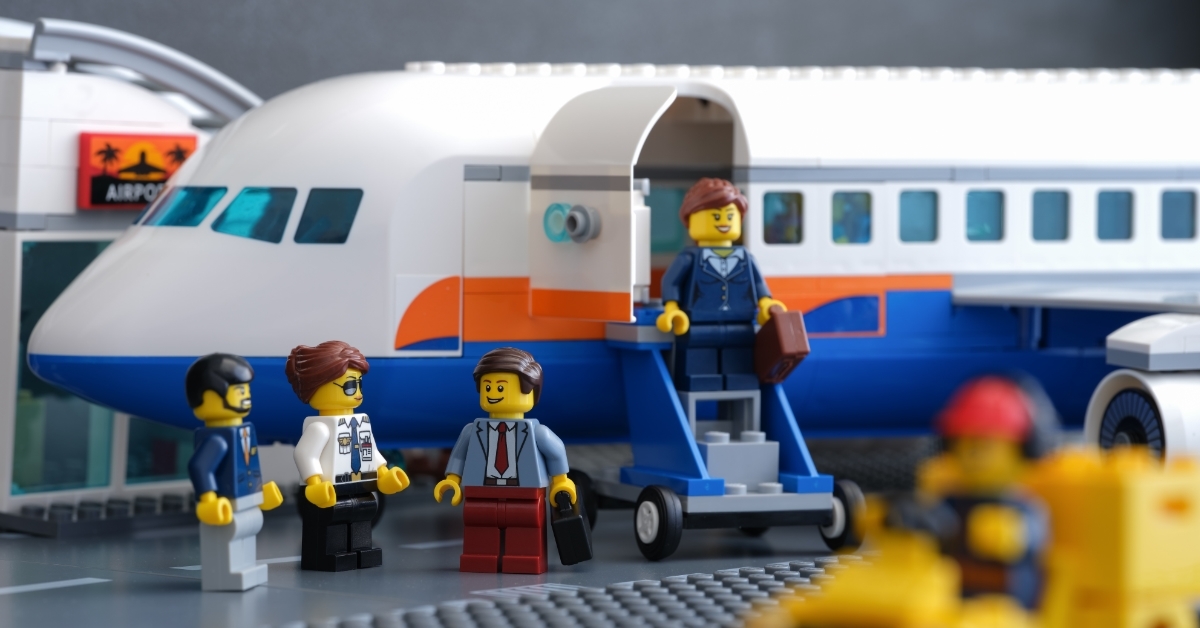 Lego businesspeople minifigures besides private jet