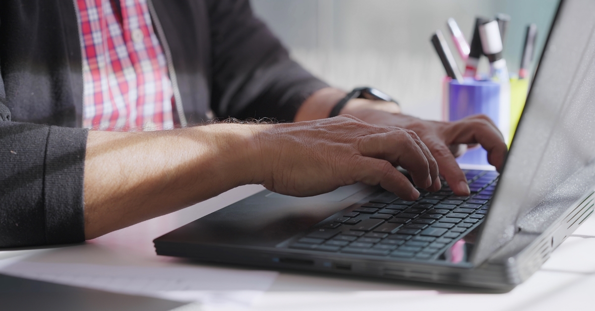man working from home using laptop