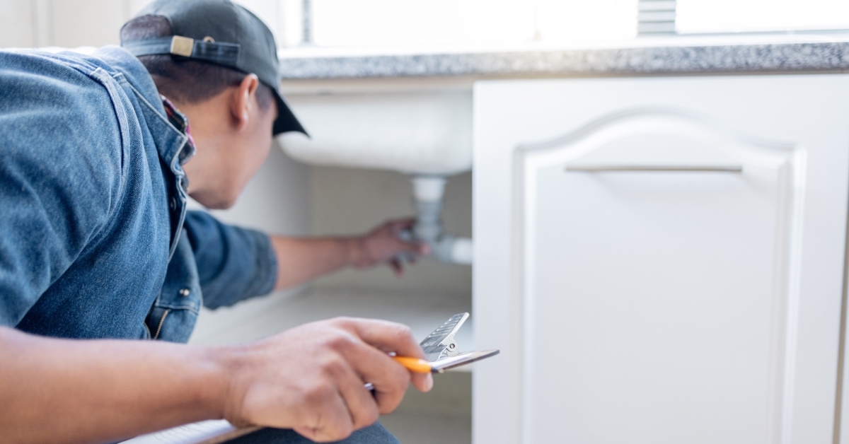 plumber fixing kitchen sink