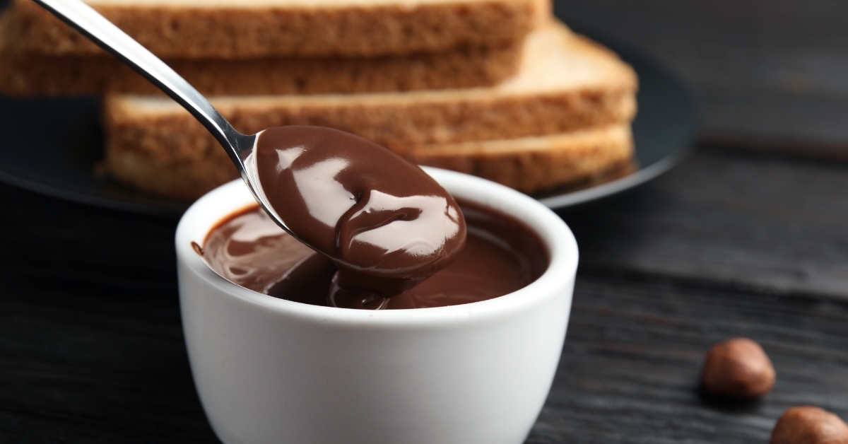 Spoon with tasty chocolate cream