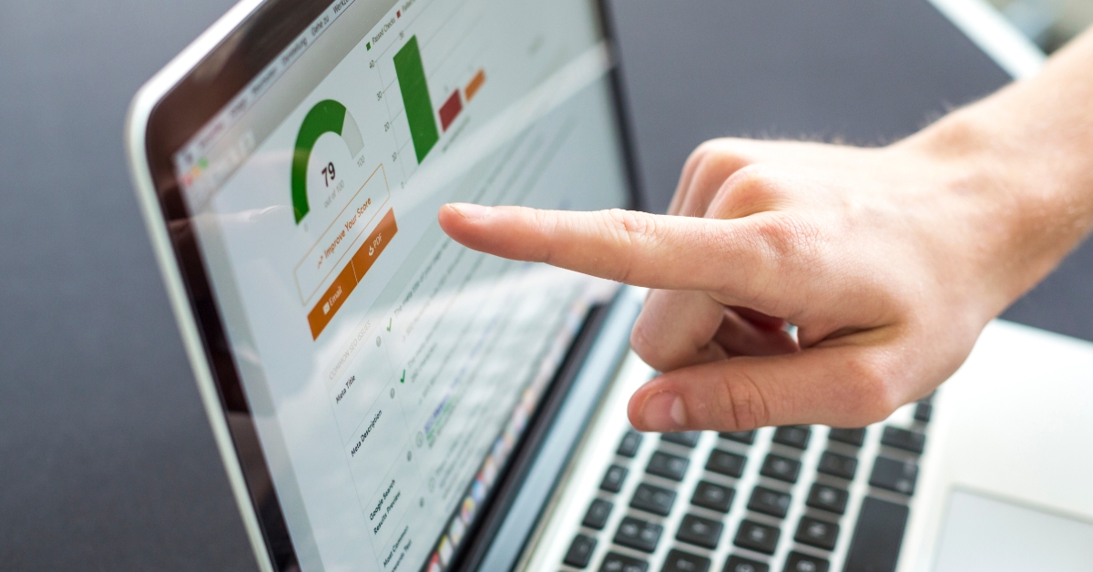 A hand near a laptop screen