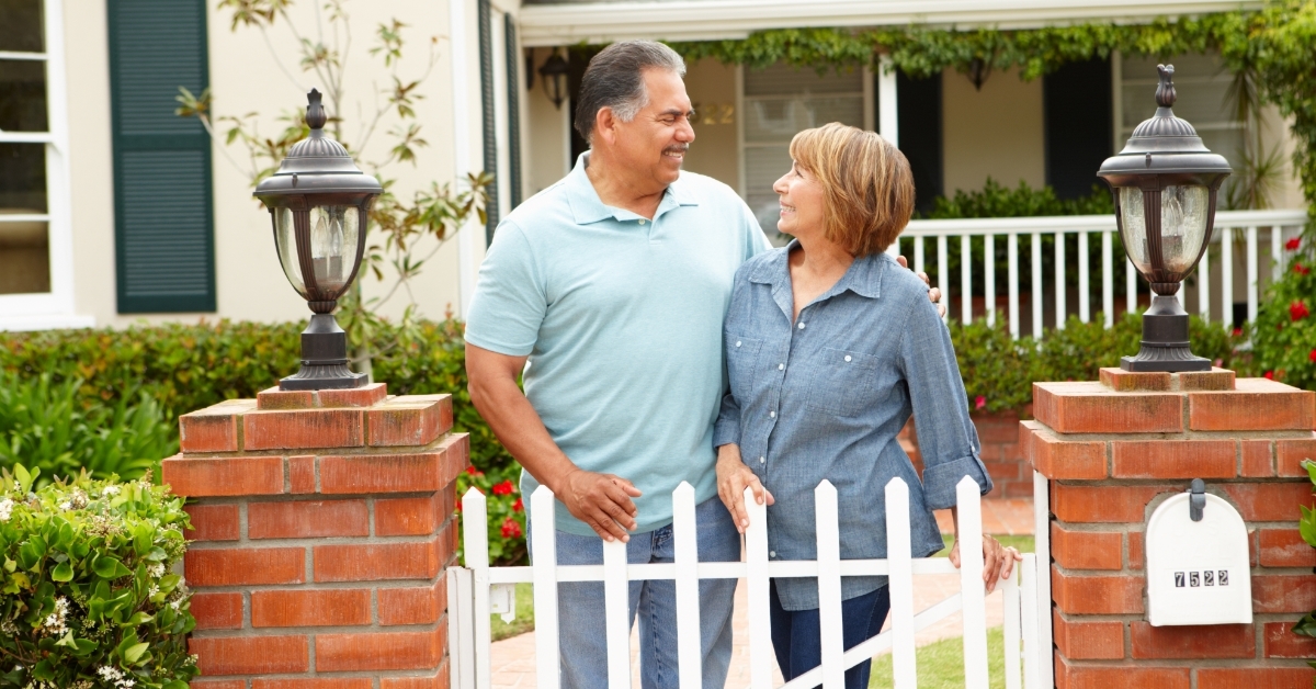 Senior Hispanic couple outside home