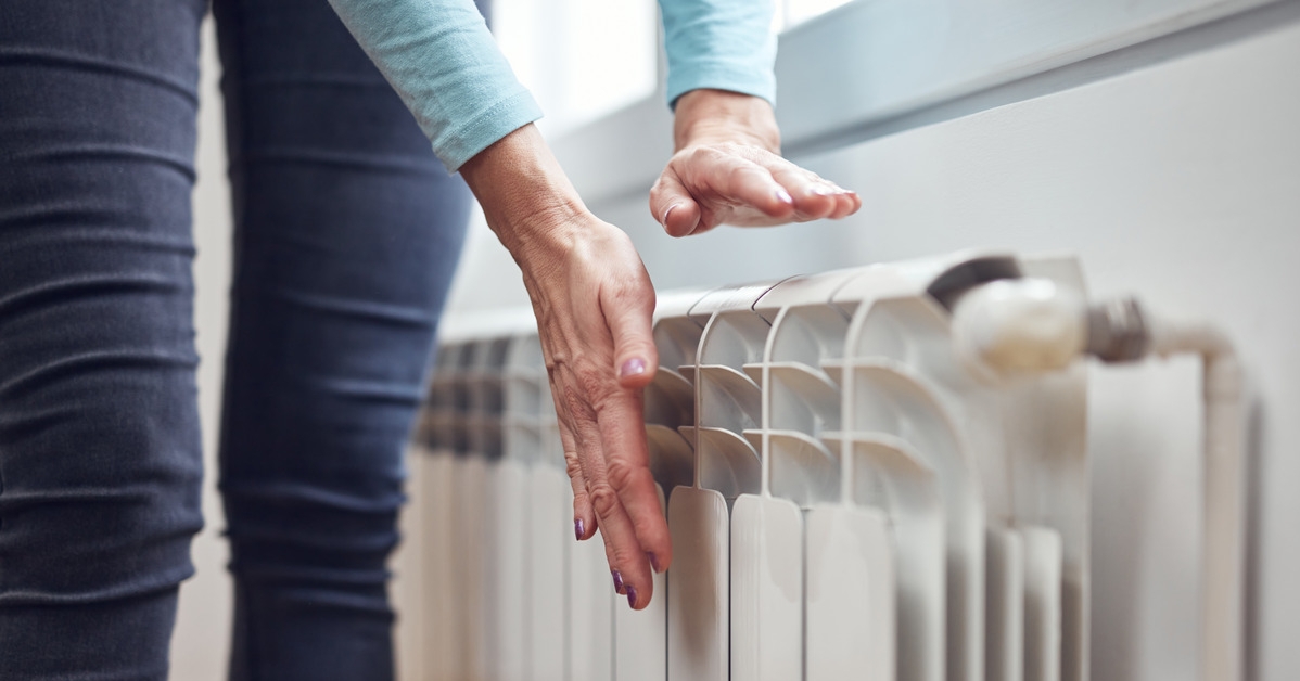woman seeing if heating works