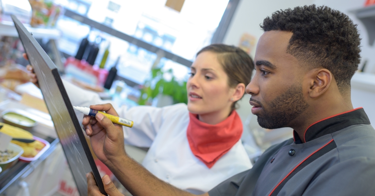 Chefs writing menu for the day 