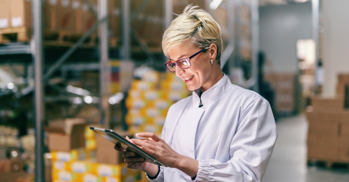 Female manager using tablet inside warehouse 