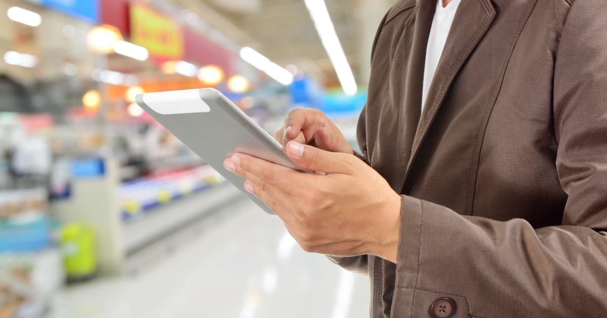 Manager using Tablet in Supermarket