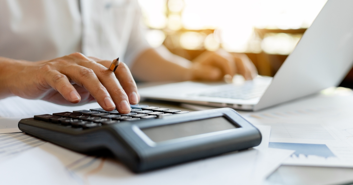 businessman pressing on calculator