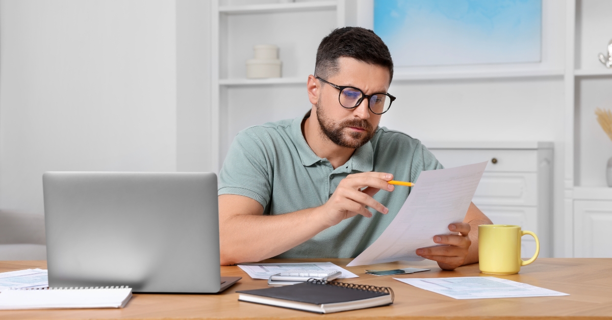 man doing taxes at table