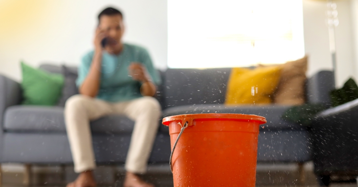 man stressed about leaked roof