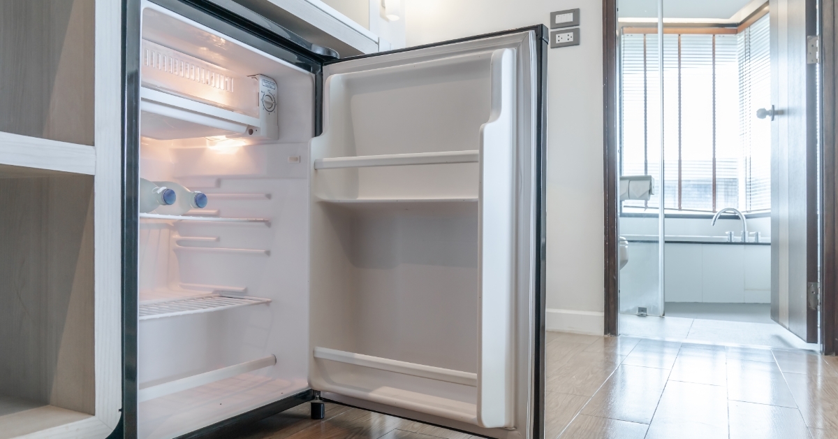 opened refrigerator under kitchen counter