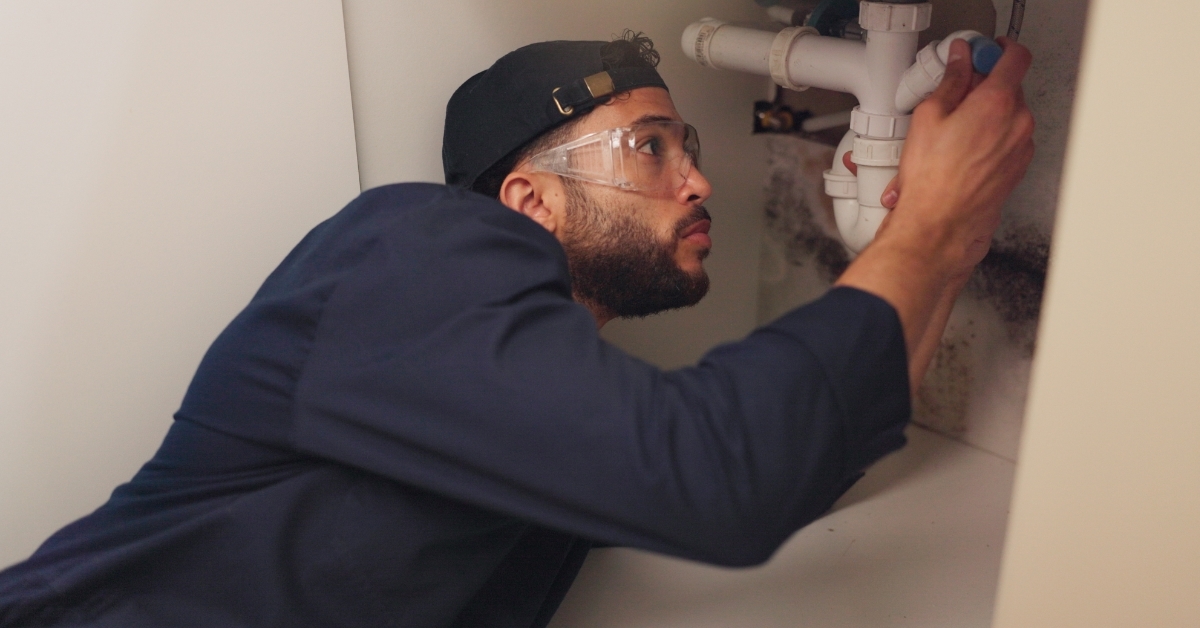 plumber fixing kitchen sink