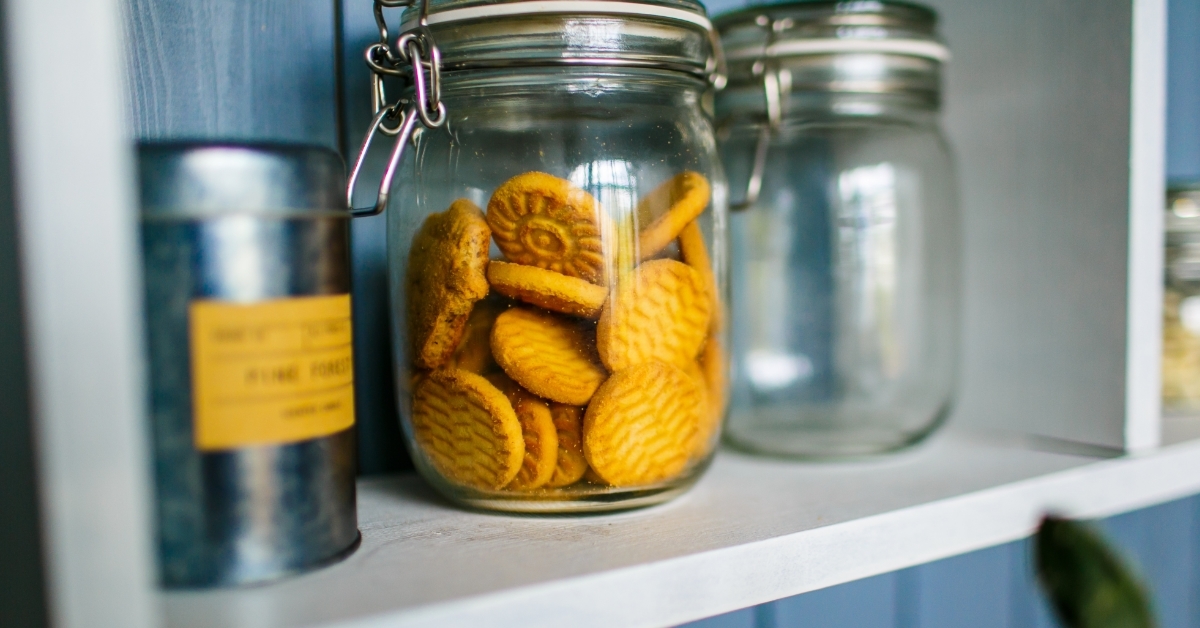 Transparent jar of cookies in kitchen 