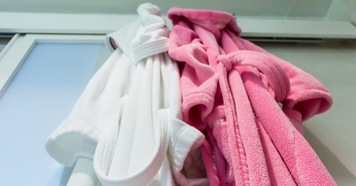 Two towelling bathrobes hanging