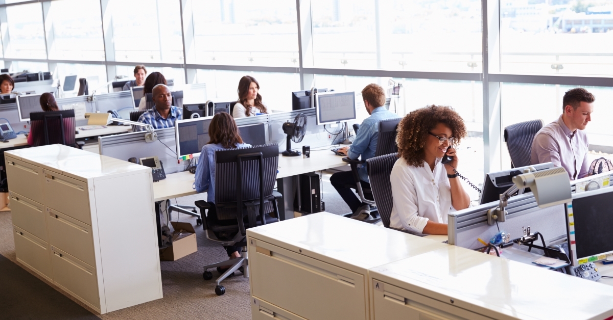 workers in busy open plan office 