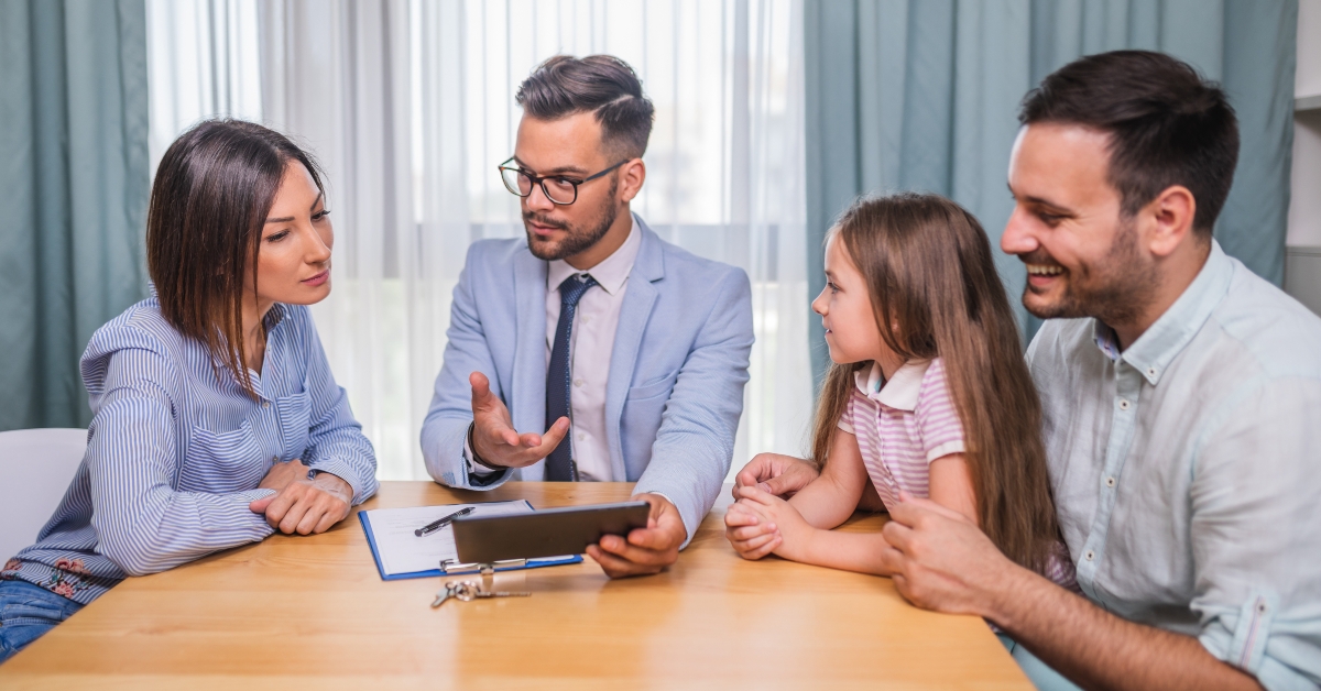Happy family talking with agent