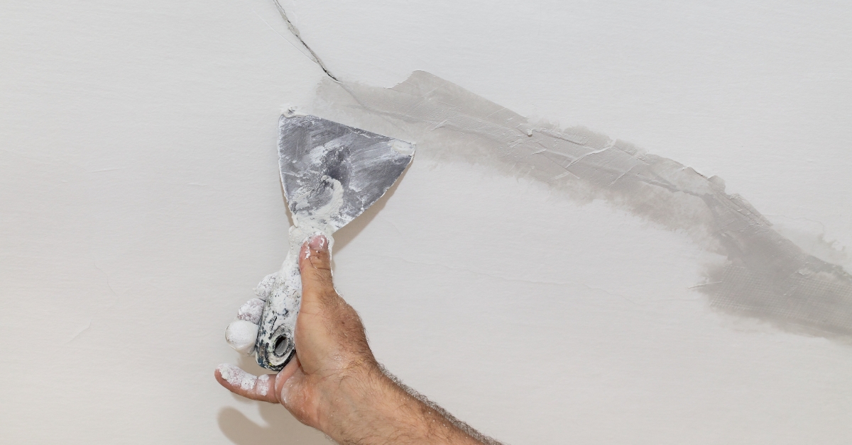 worker fixing cracks