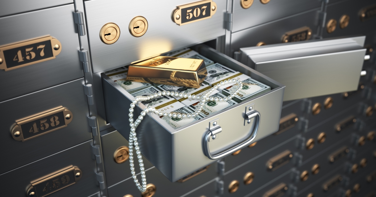 money, jewels and golden ingot in a deposit box