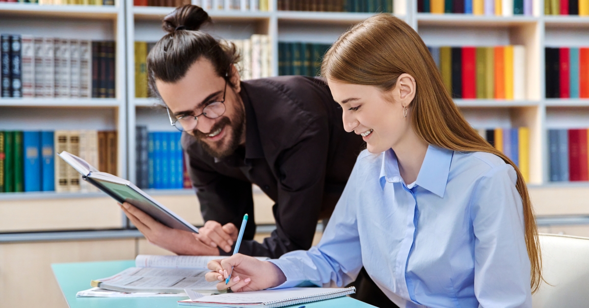 student girl studying with male teacher