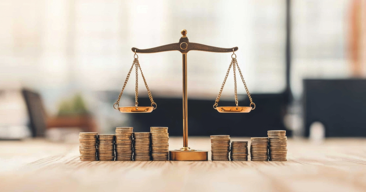 tilted weighing scale balancing coins