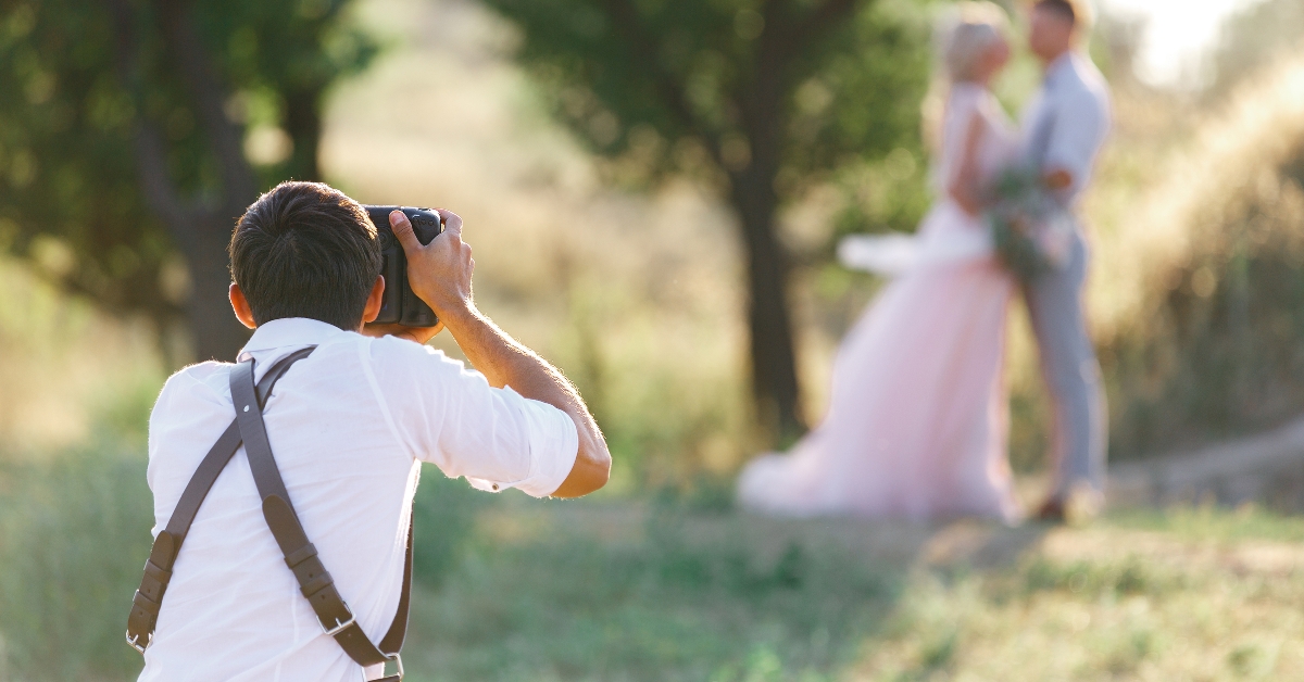 wedding photographer takes pictures of bride and groom 
