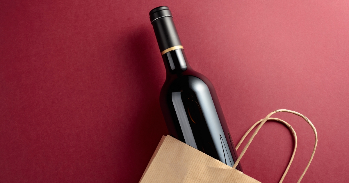 shopping bag with a bottle of red wine