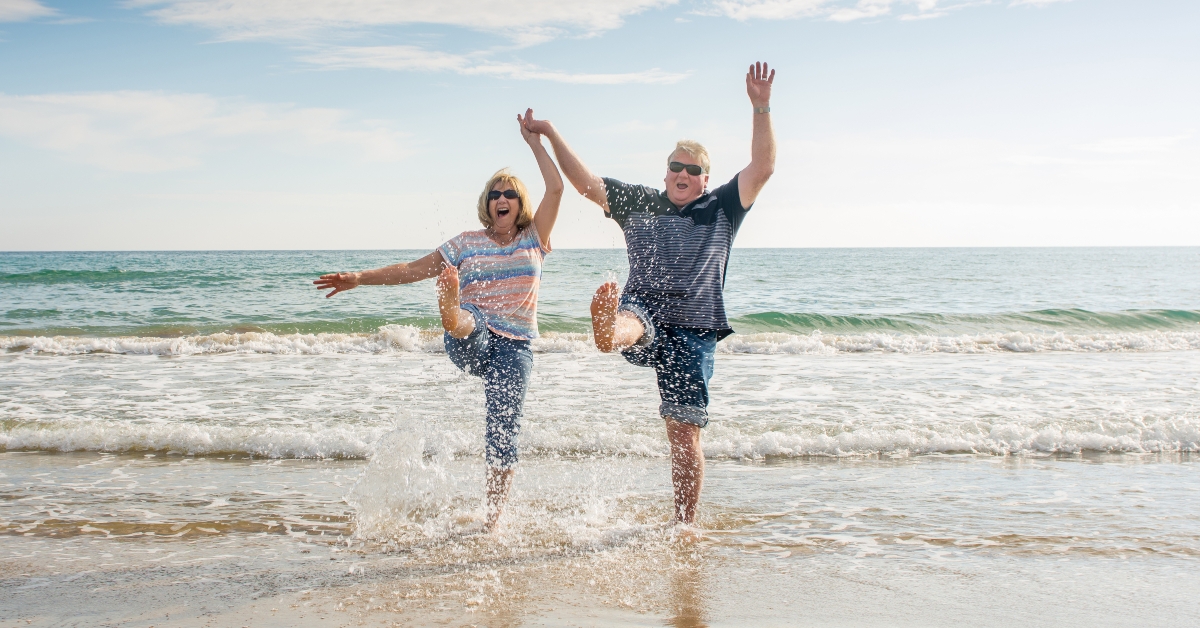 couple walking on beach having fun